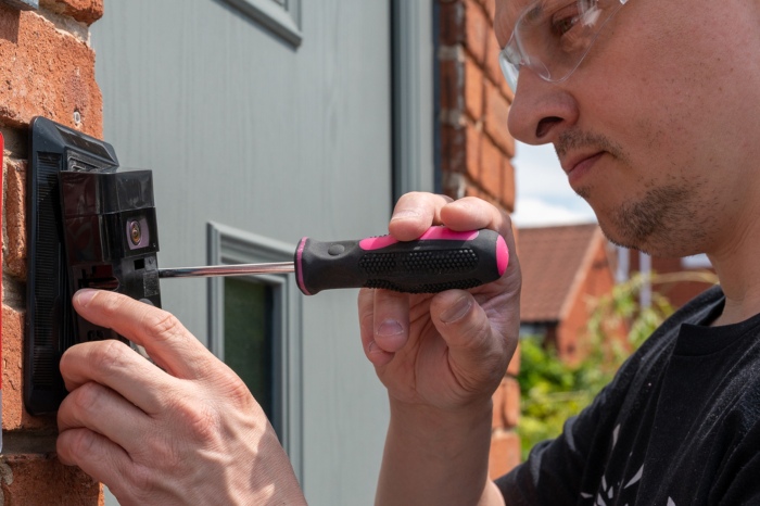 Man installing a smart doorbell